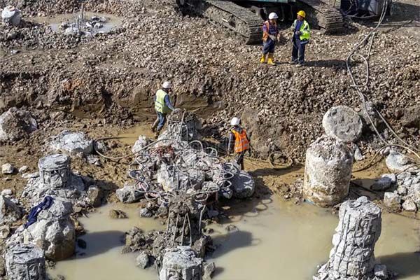 Pile breaking and crushing at a construction site